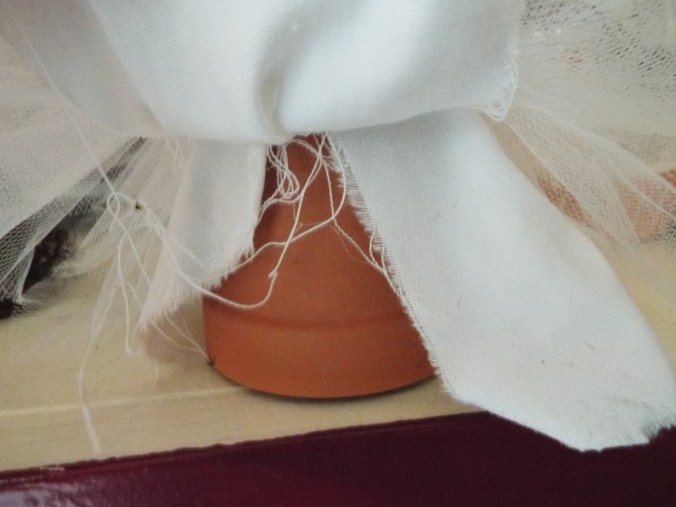 The upside down clay pot for a sturdy base and shape for the 'skirt'.